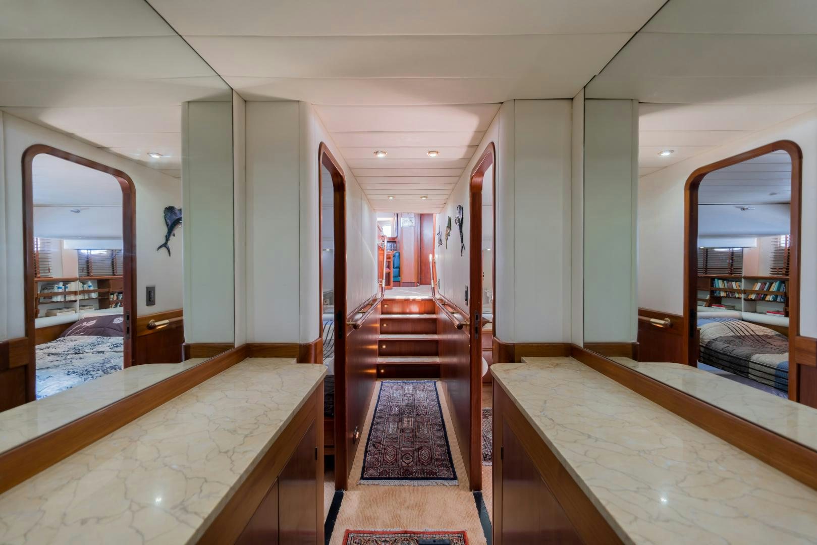 a room with a bed and a mirror aboard TARONGA Yacht for Sale