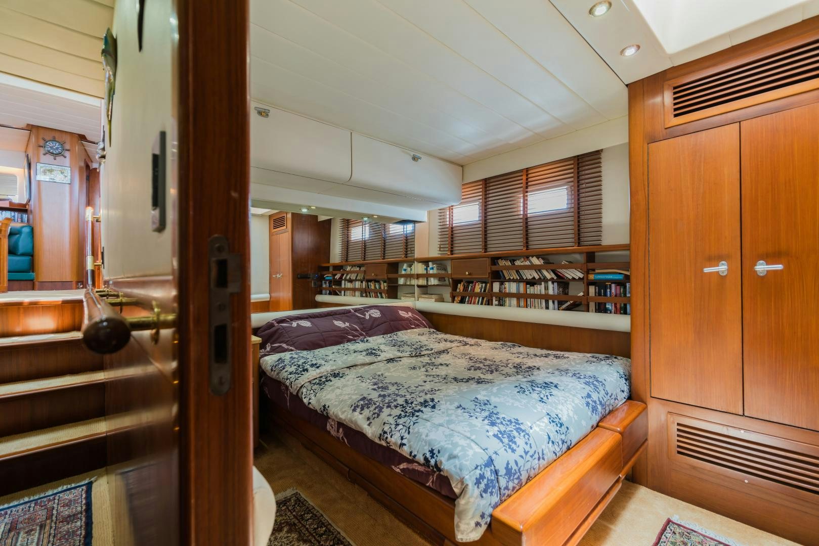 a bedroom with a bed and a closet aboard TARONGA Yacht for Sale