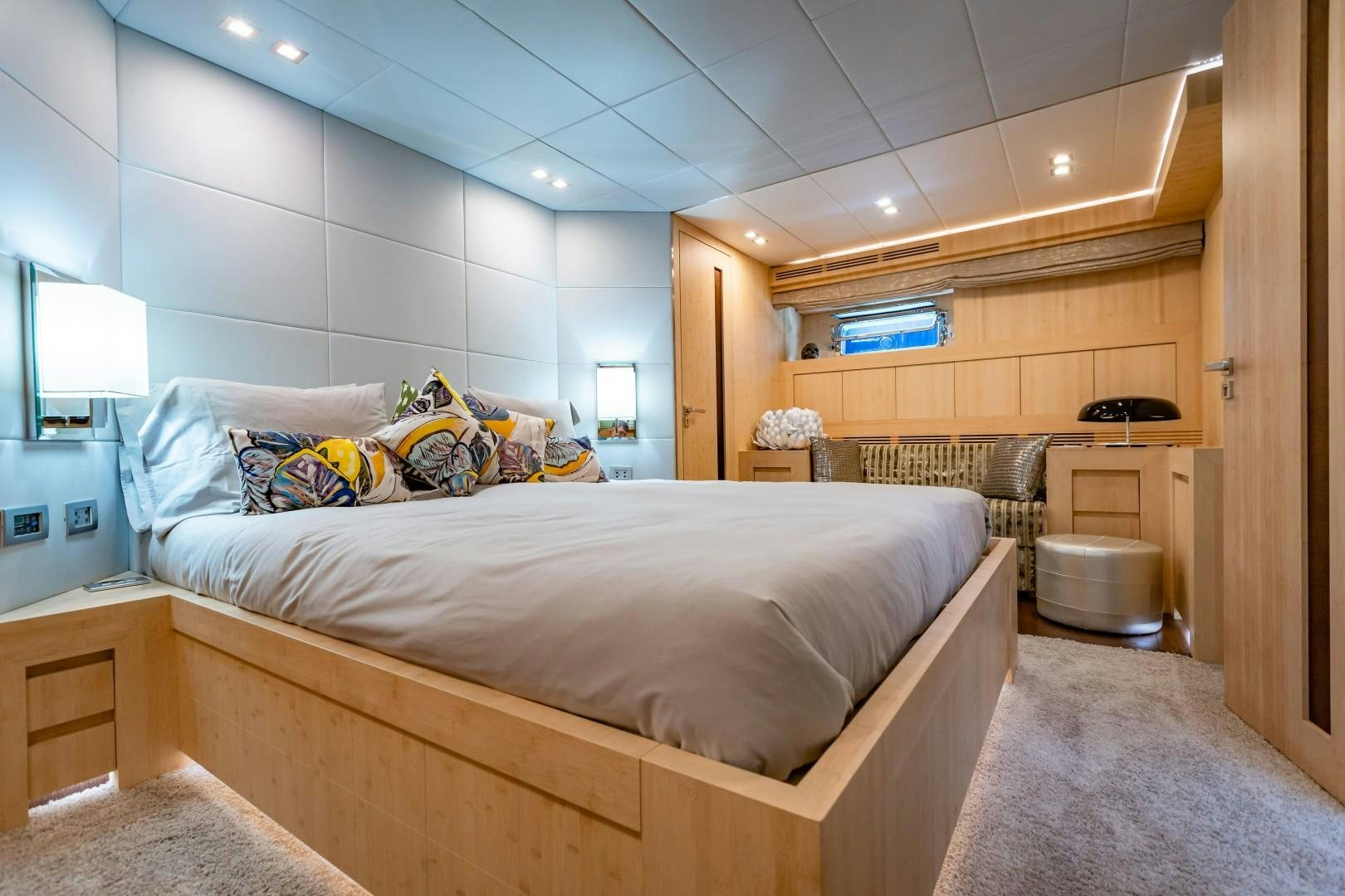 a bedroom with a bed and a desk aboard REVEIL Yacht for Sale