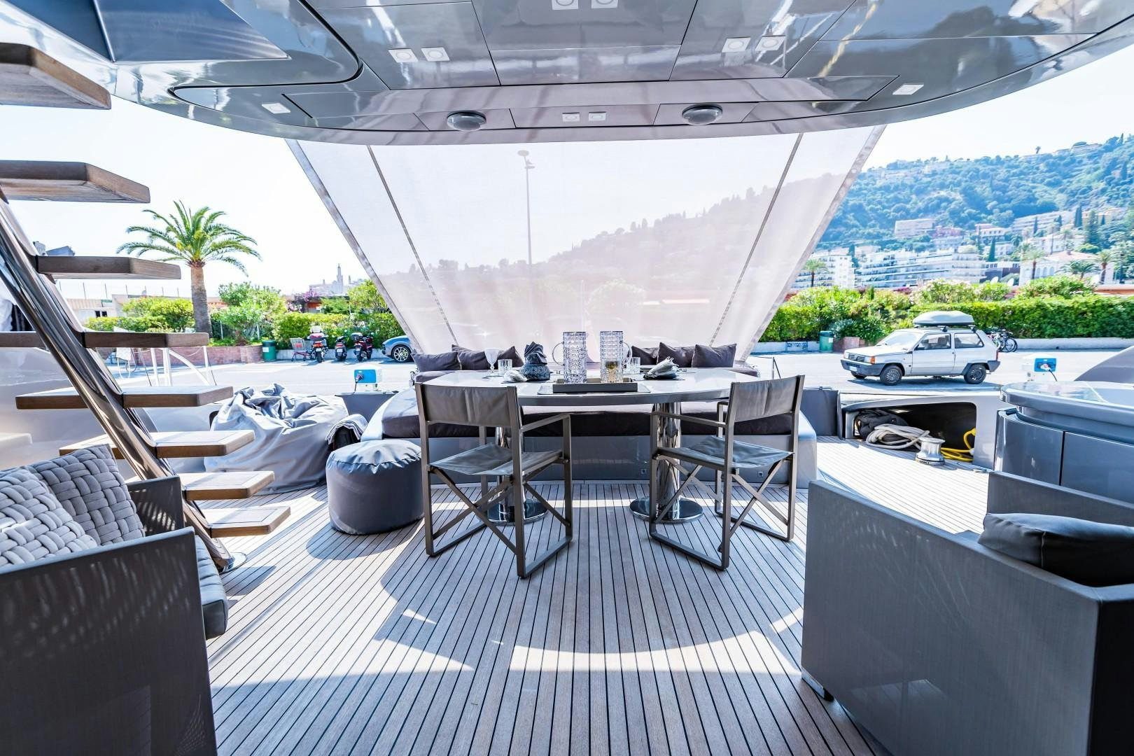 a patio with a table and chairs aboard REVEIL Yacht for Sale