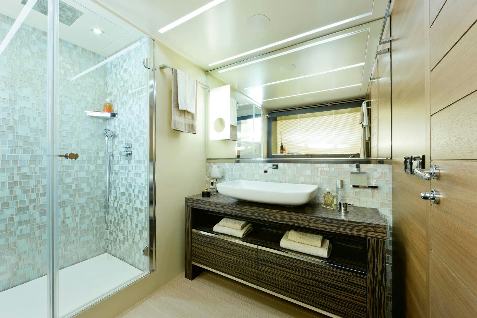 a bathroom with a glass shower aboard DORIS Yacht for Sale