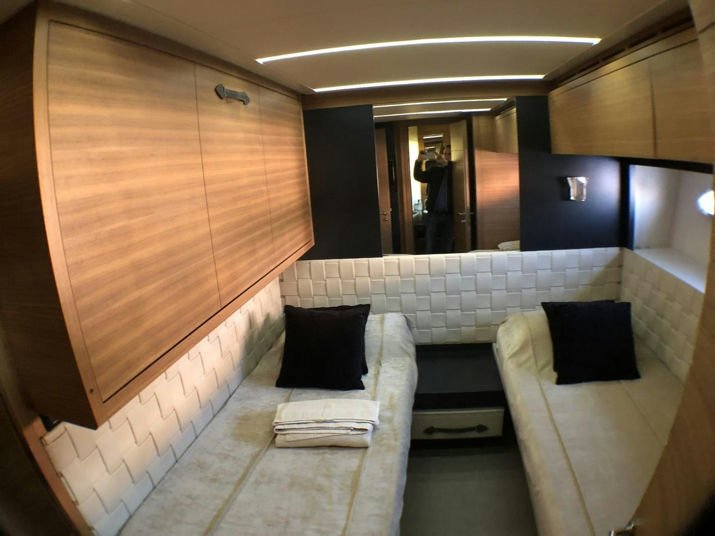 a room with a bed and a chair aboard DORIS Yacht for Sale