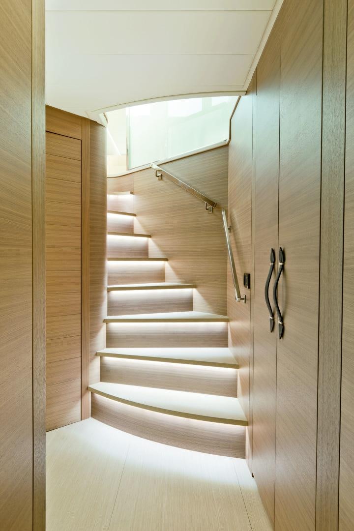 a white staircase with a glass door aboard DORIS Yacht for Sale