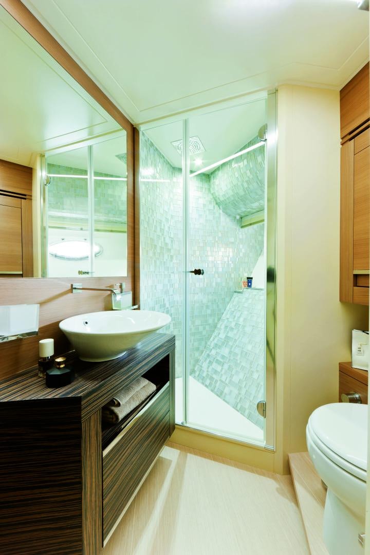 a bathroom with a glass shower aboard DORIS Yacht for Sale