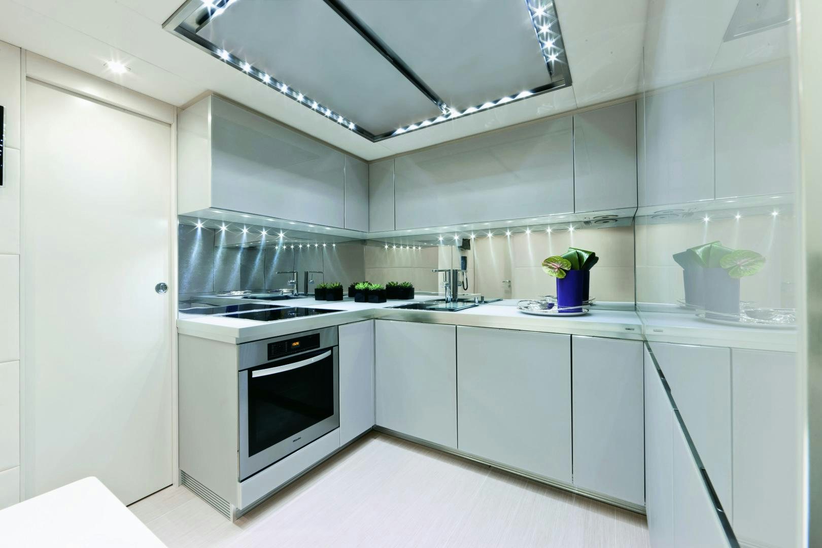 a kitchen with white cabinets aboard DORIS Yacht for Sale