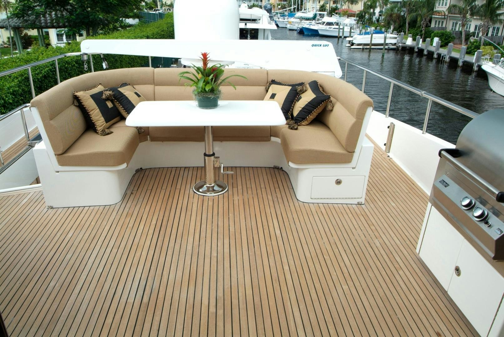 a couch and a table in a room with a pool aboard MABUHAY LIMA Yacht for Sale