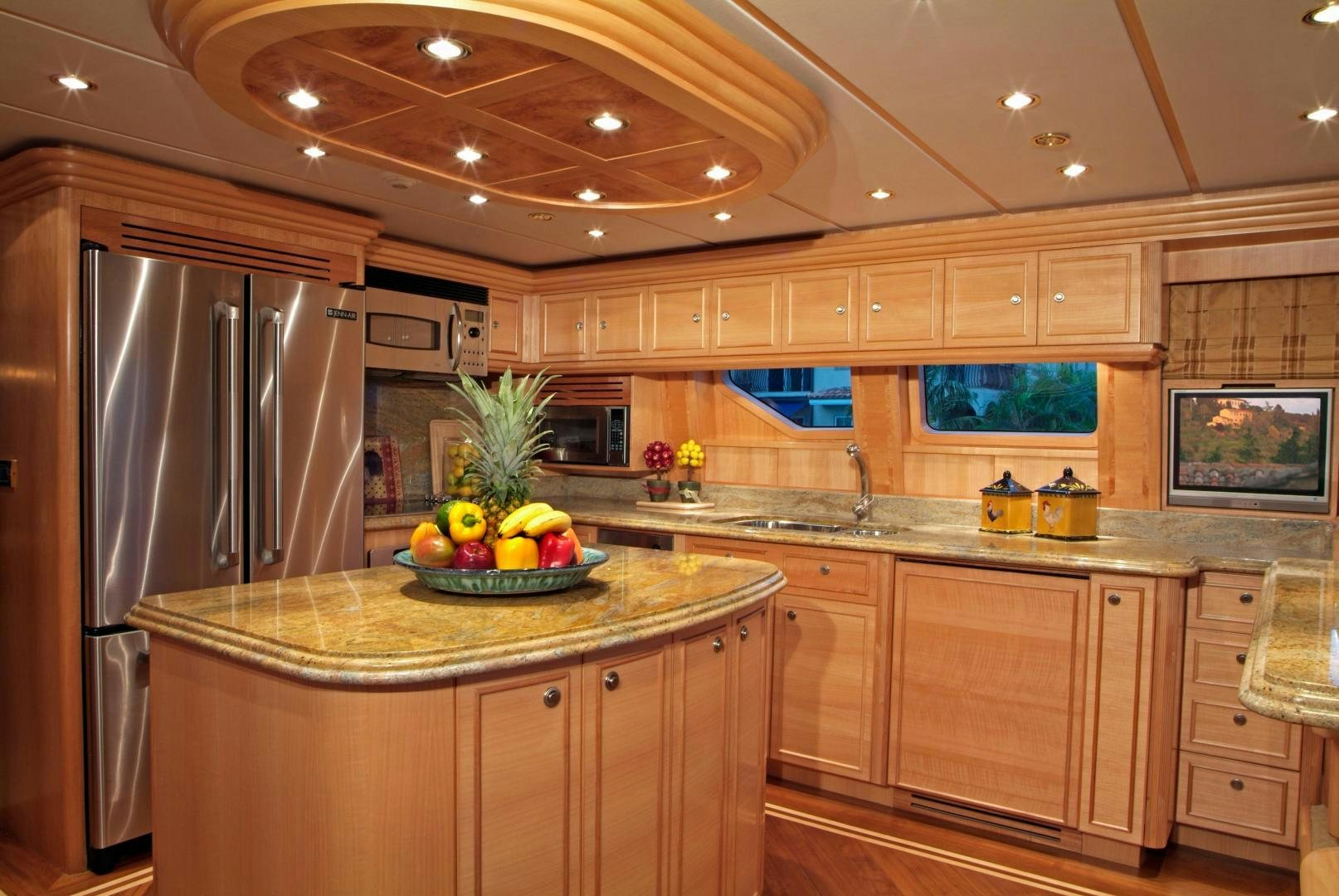 a kitchen with a stainless steel refrigerator aboard MABUHAY LIMA Yacht for Sale