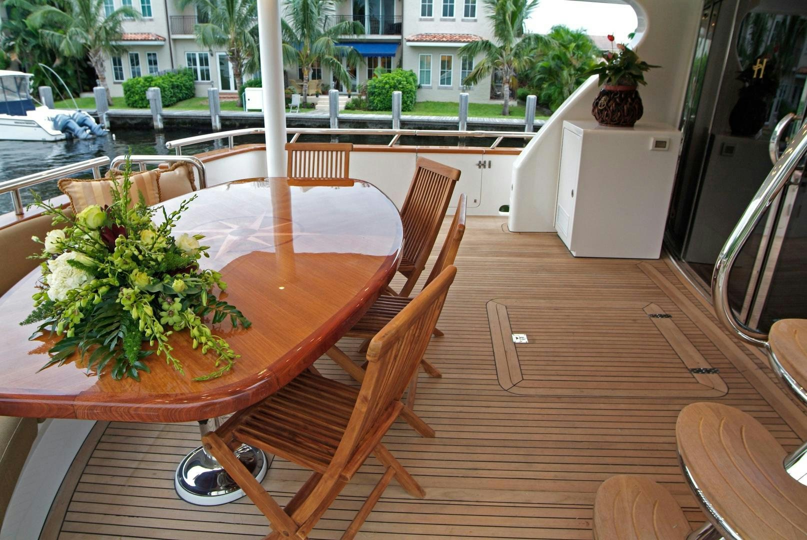 a table with chairs and plants on it aboard MABUHAY LIMA Yacht for Sale