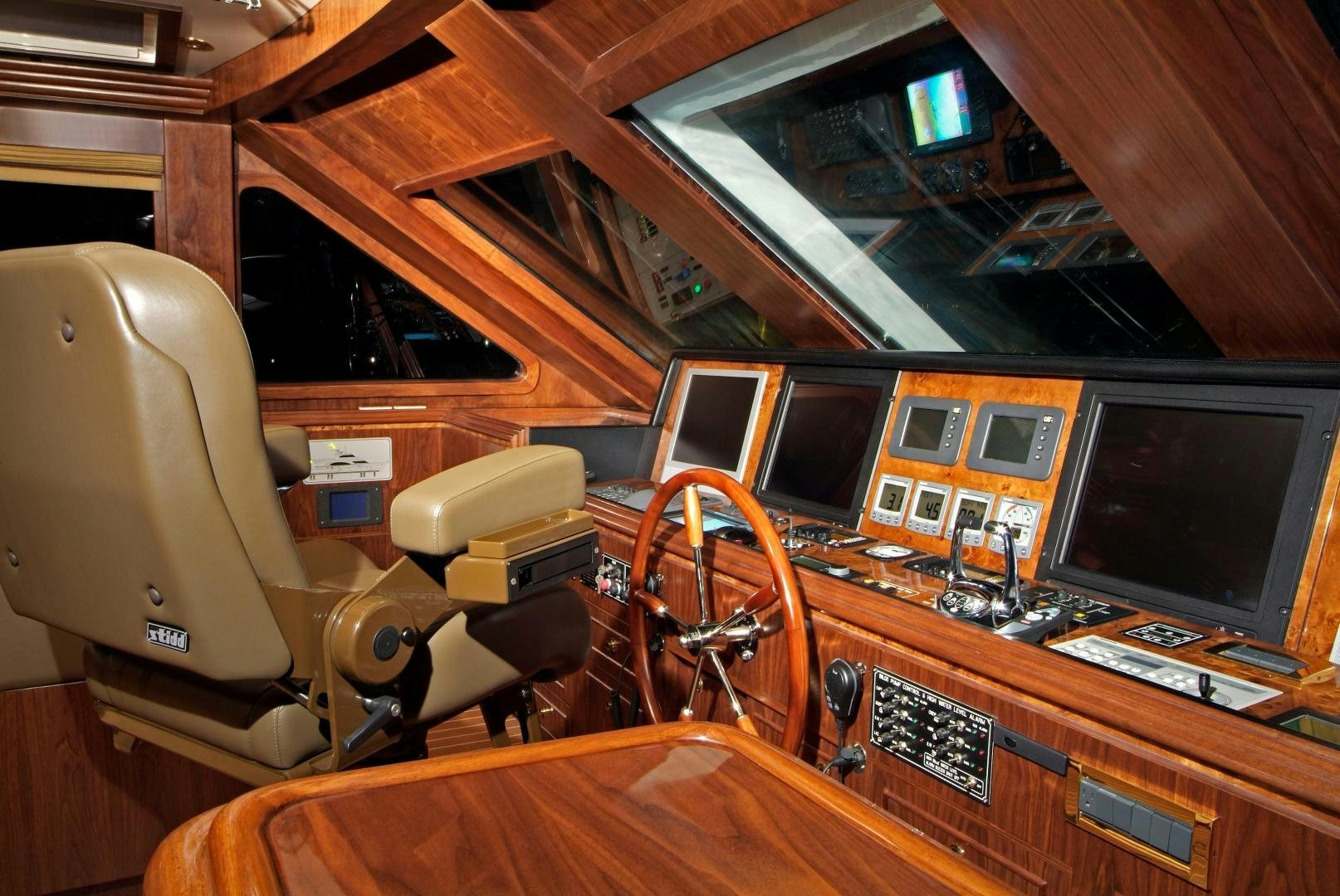 a wooden boat with a computer and a desk with a chair and computer aboard MABUHAY LIMA Yacht for Sale