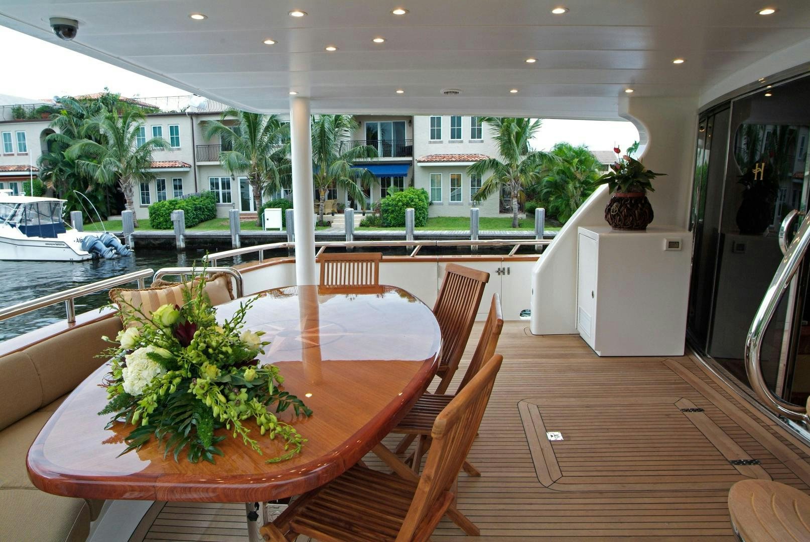 a table with chairs and plants on it aboard MABUHAY LIMA Yacht for Sale