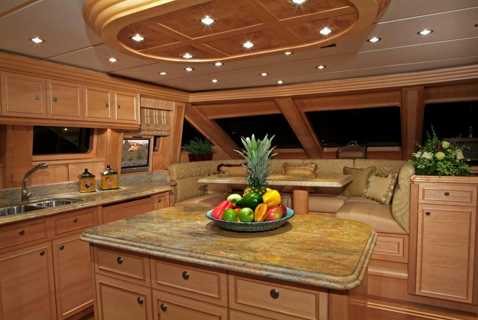 a kitchen with a large island aboard MABUHAY LIMA Yacht for Sale