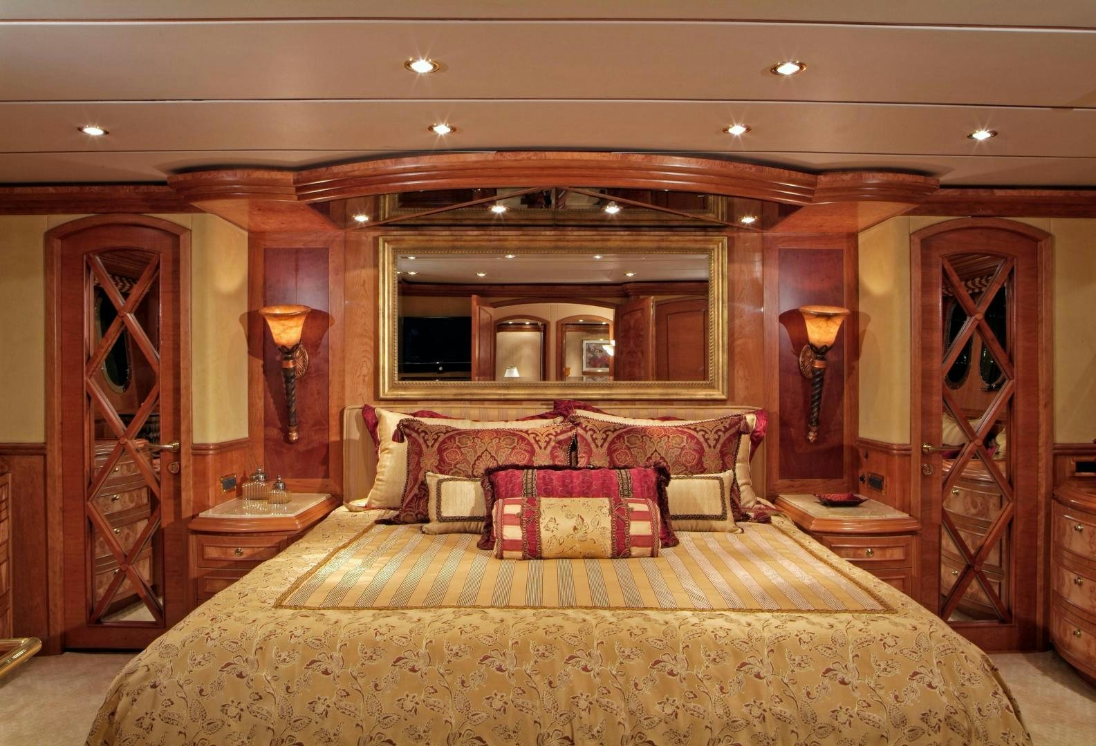 a large bedroom with a bed and a mirror aboard MABUHAY LIMA Yacht for Sale