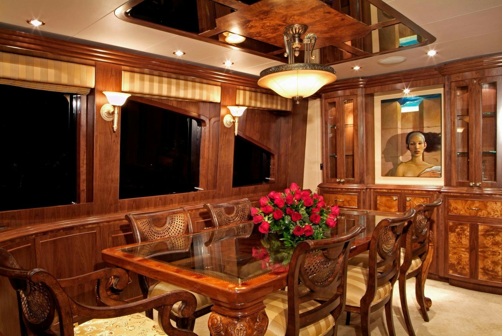 a dining room with a table and chairs aboard MABUHAY LIMA Yacht for Sale