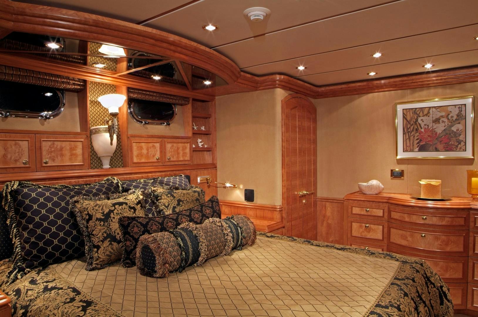 a large living room with a large sofa and a fireplace aboard MABUHAY LIMA Yacht for Sale