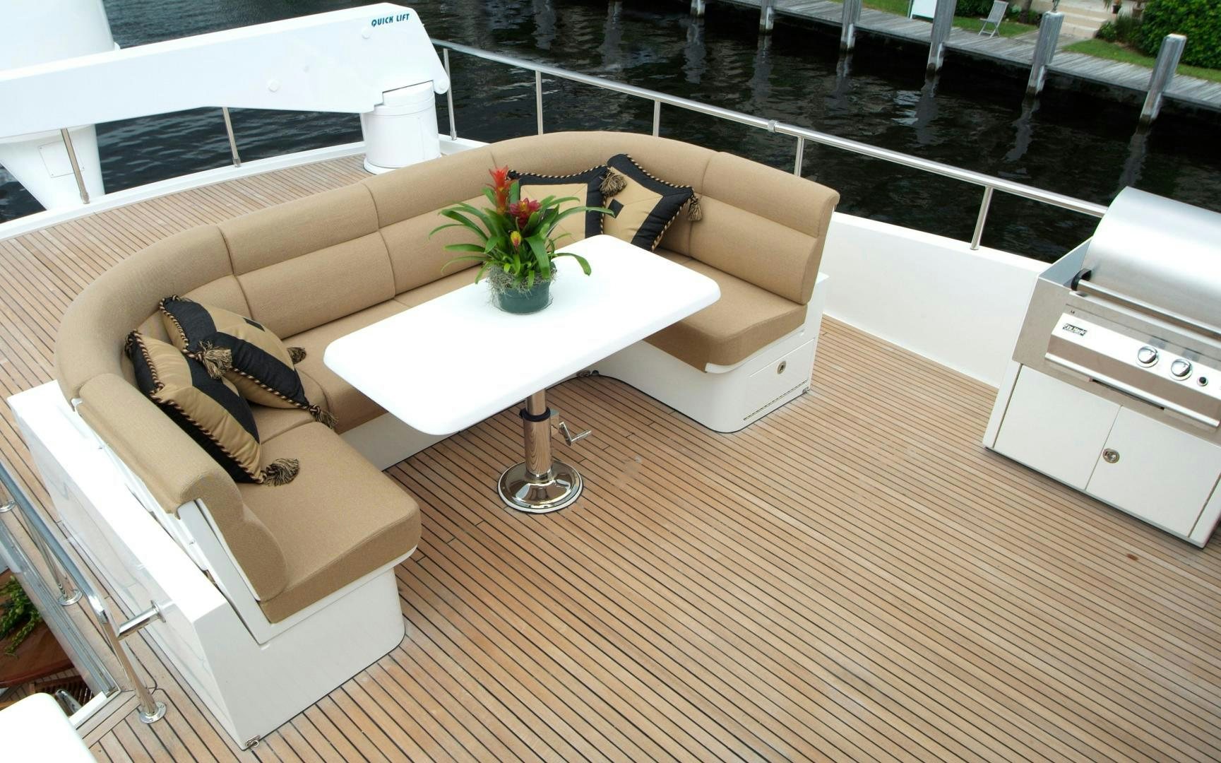 a room with a couch and a table with a plant on it aboard MABUHAY LIMA Yacht for Sale