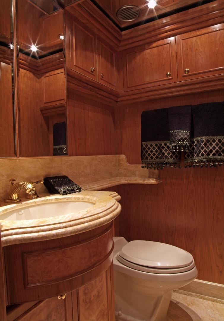 a bathroom with wooden cabinets aboard MABUHAY LIMA Yacht for Sale
