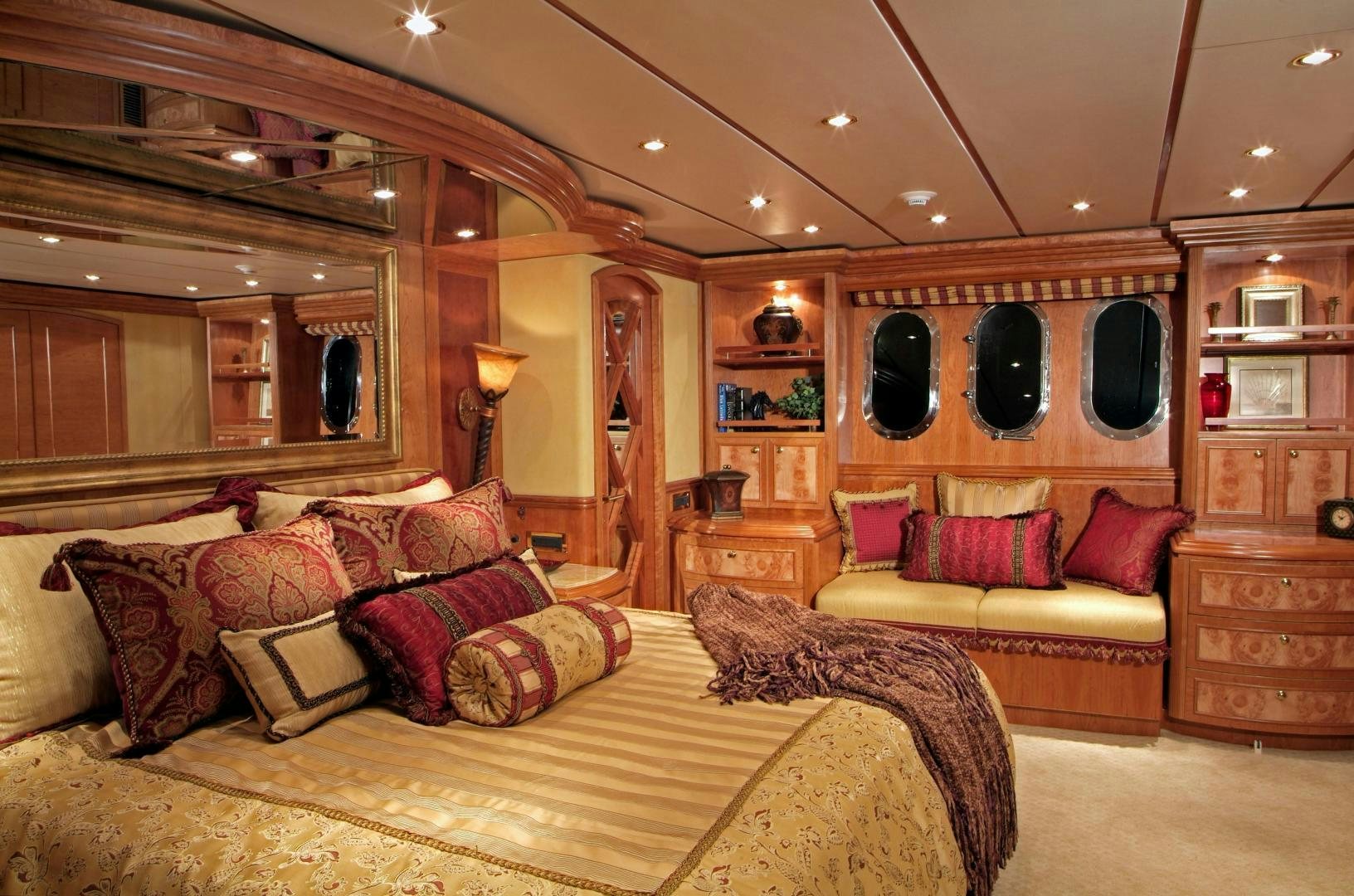 a large living room with a large bed and a large mirror aboard MABUHAY LIMA Yacht for Sale