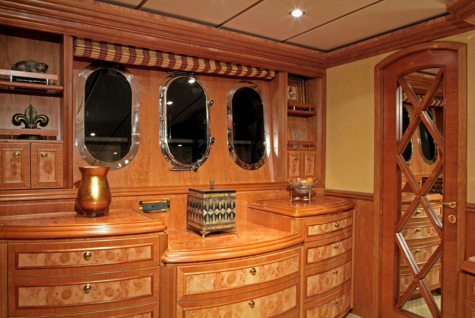 a room with wooden cabinets aboard MABUHAY LIMA Yacht for Sale