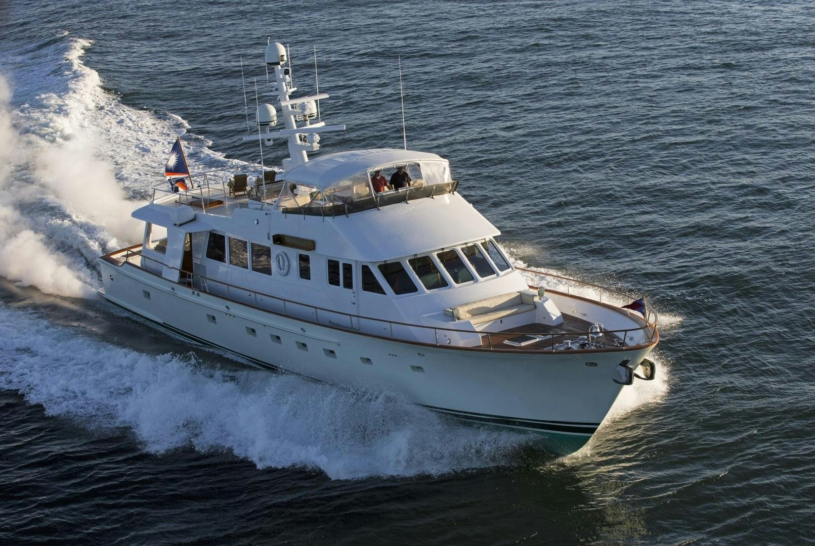 a boat on the water aboard CUSTOM HUNT 90’  Yacht for Sale
