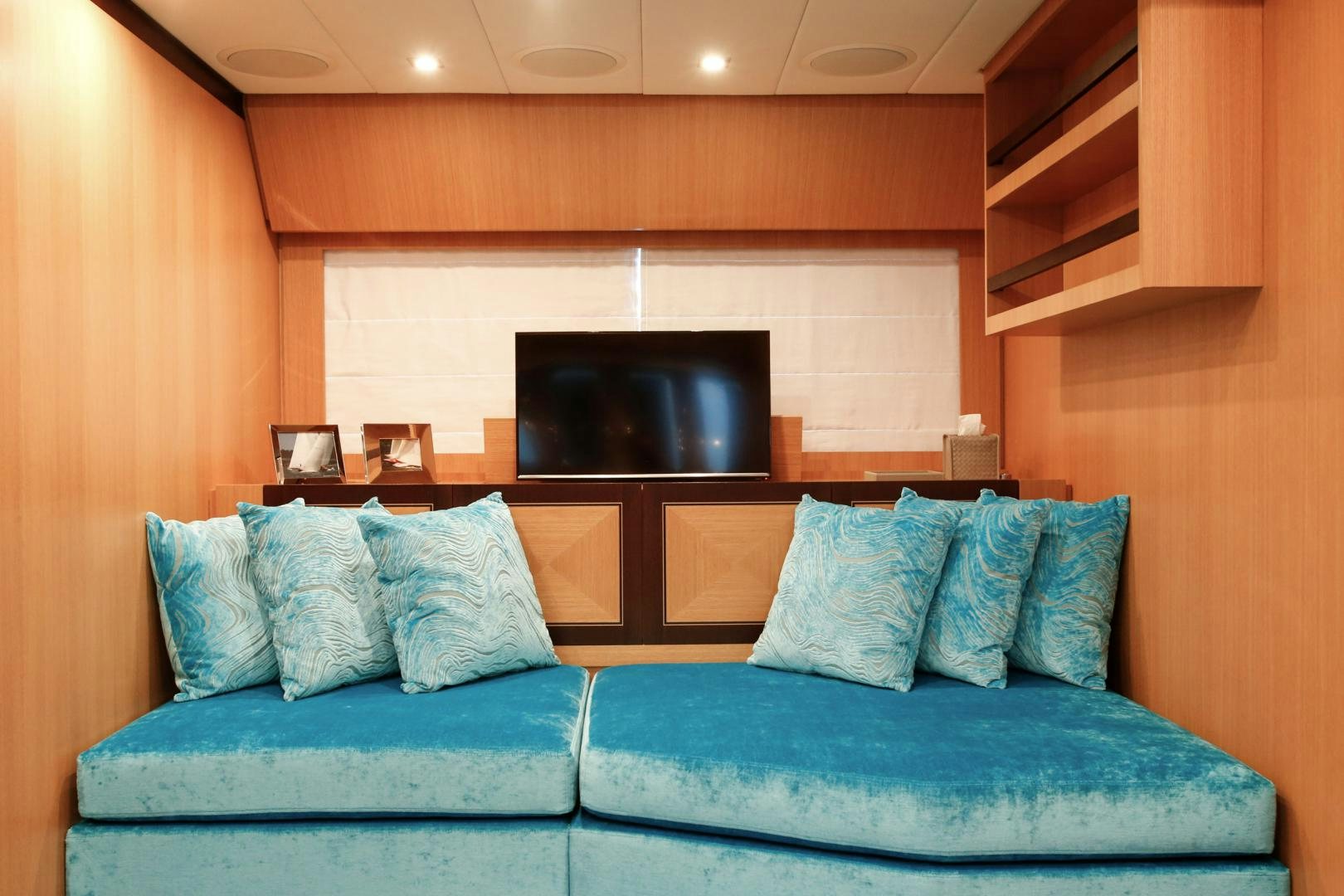 a blue couch in a room aboard THE OFFICE Yacht for Sale