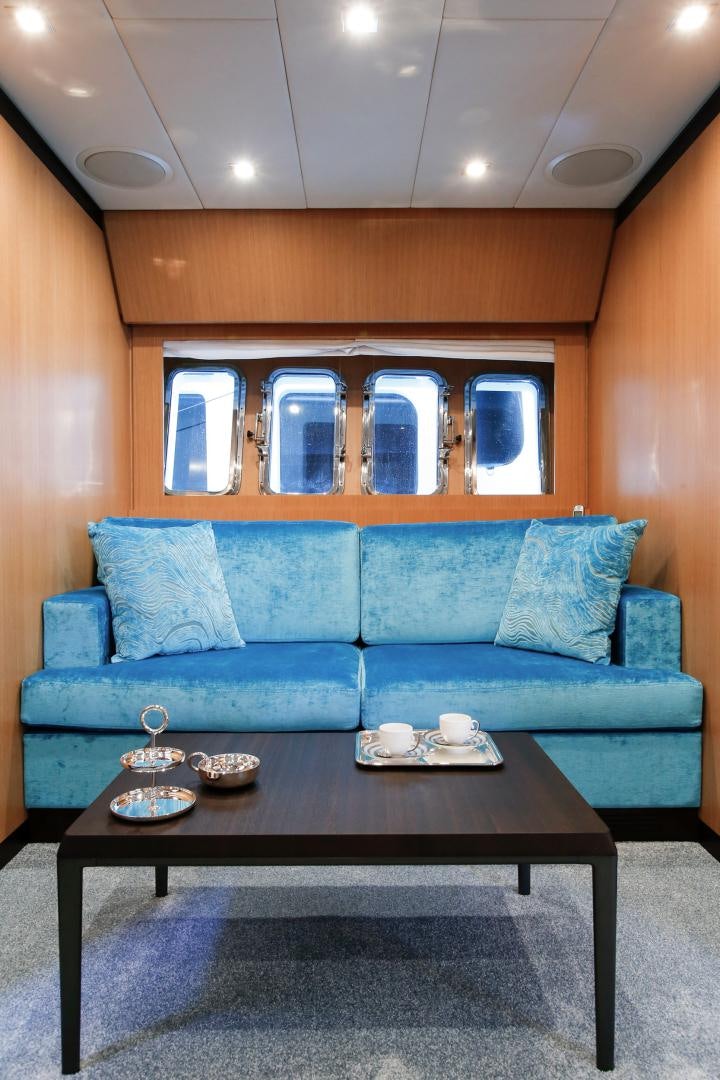 a couch with a coffee table aboard THE OFFICE Yacht for Sale