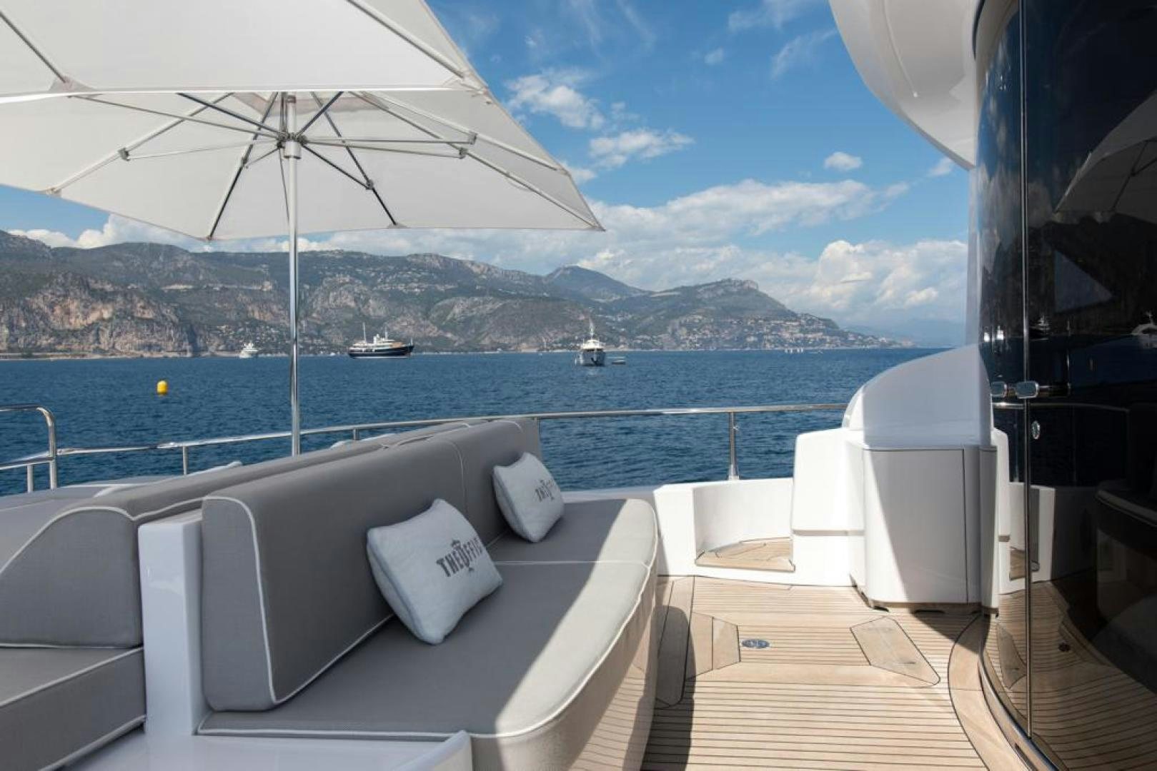 a bathtub and a view of the ocean and mountains aboard THE OFFICE Yacht for Sale