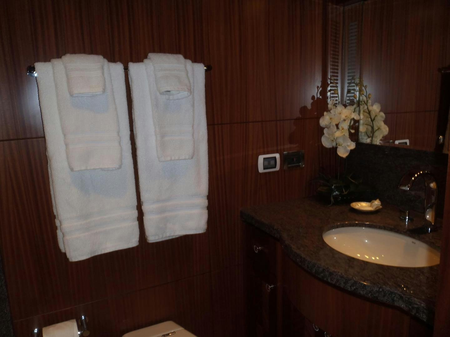 a bathroom with a sink and towels aboard CLAYPEN Yacht for Sale