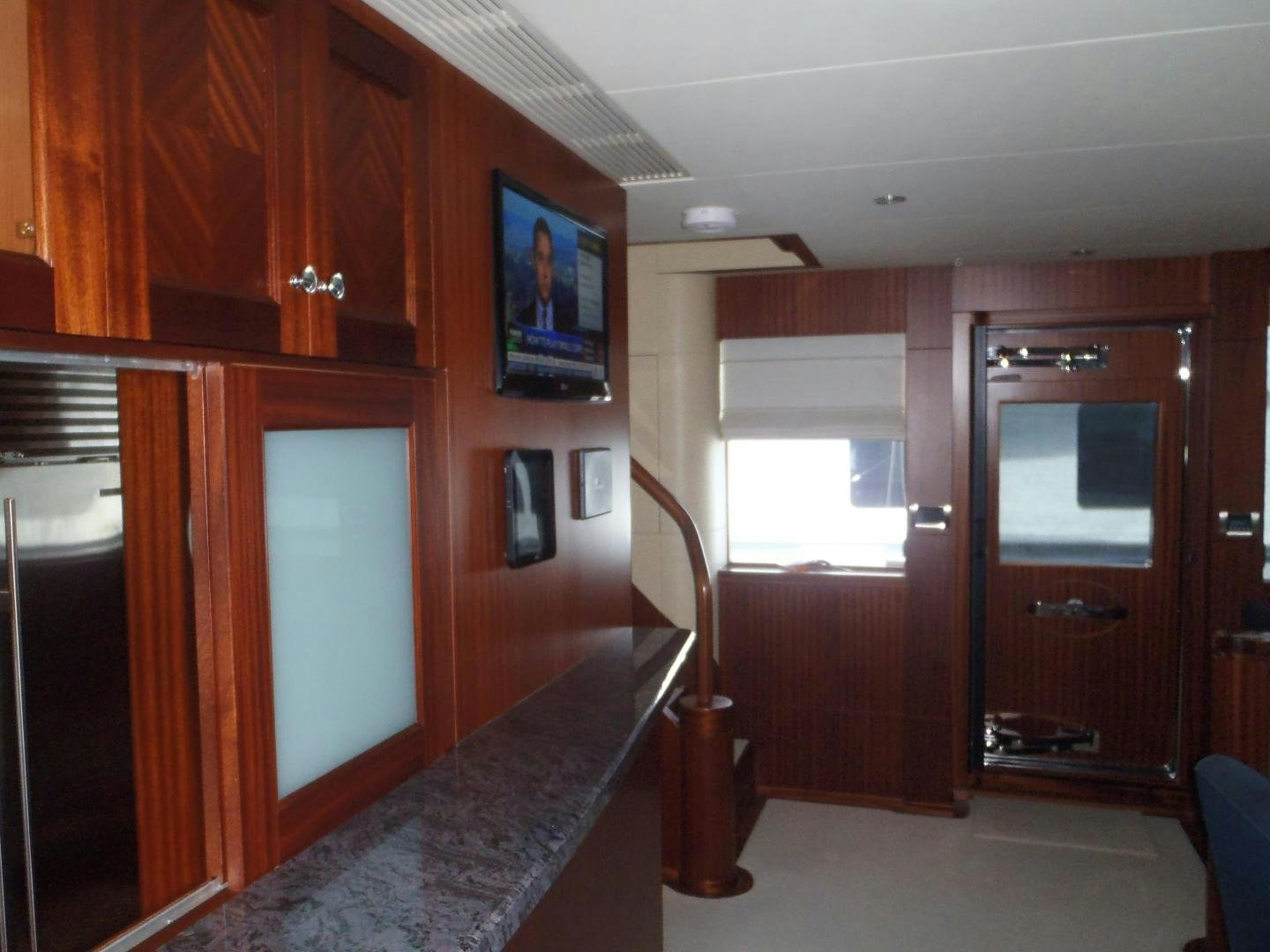 a kitchen with a bar and a refrigerator aboard CLAYPEN Yacht for Sale