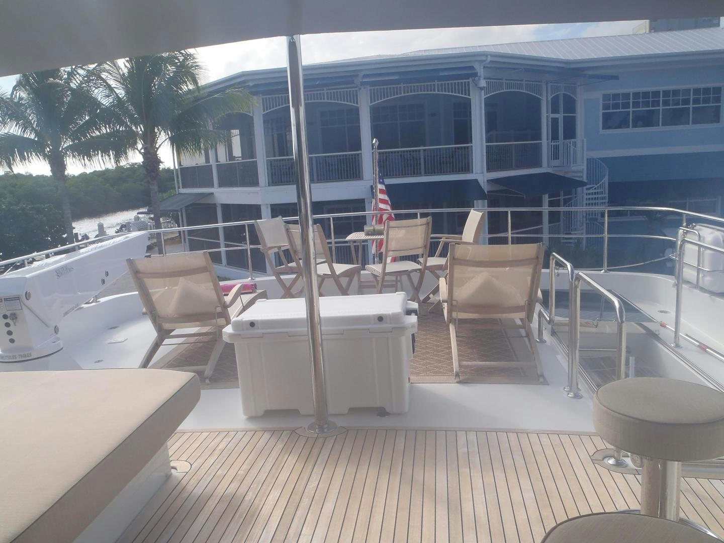 a deck with chairs and tables on it aboard CLAYPEN Yacht for Sale