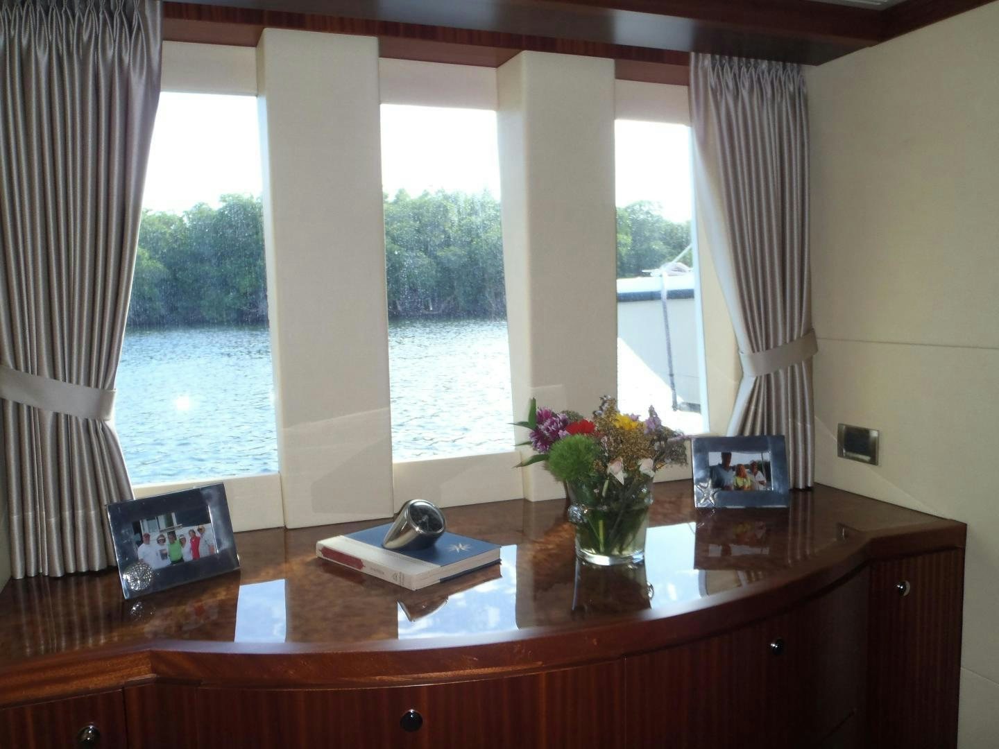 a table with a book and flowers aboard CLAYPEN Yacht for Sale