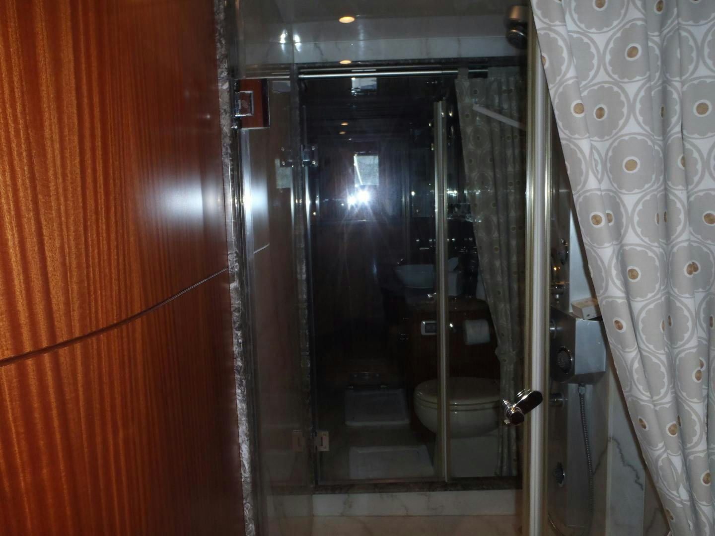 a bathroom with a glass shower aboard CLAYPEN Yacht for Sale