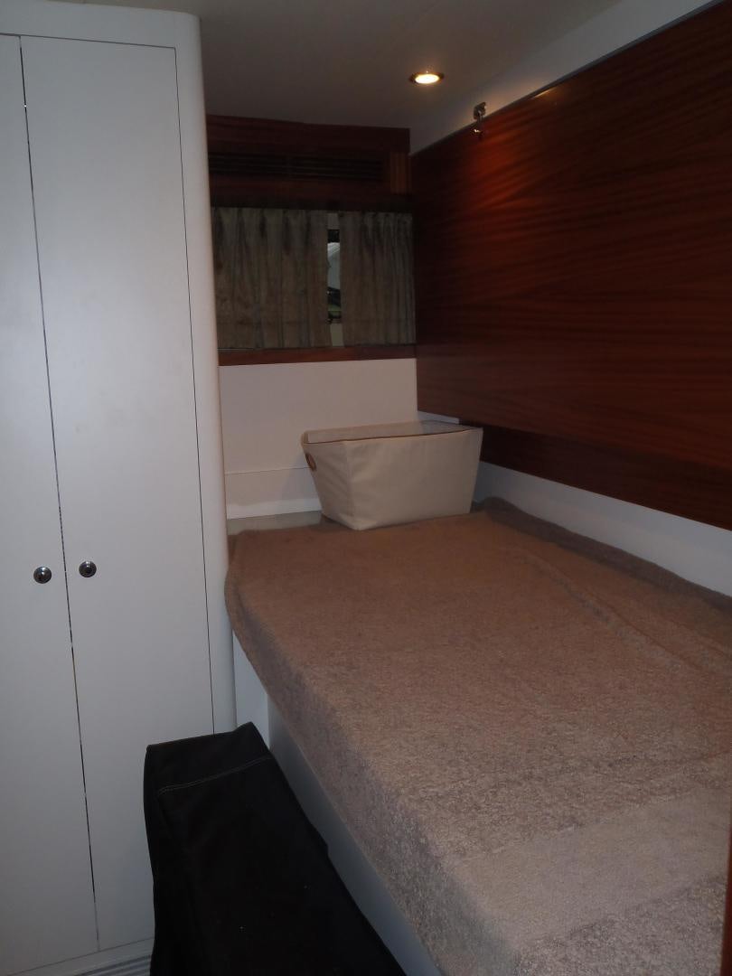 a room with a bed and a window aboard CLAYPEN Yacht for Sale