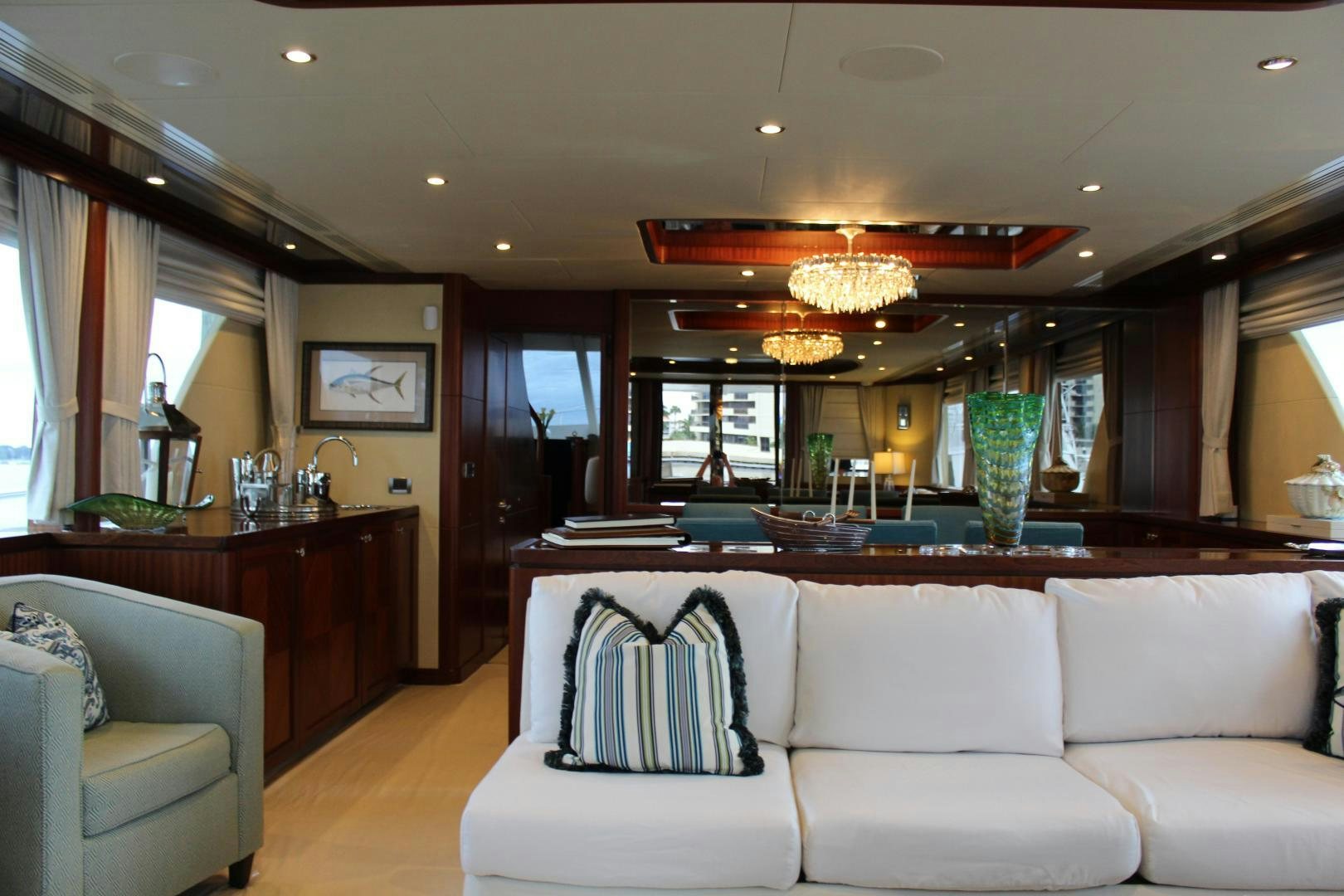 a living room with a large window aboard CLAYPEN Yacht for Sale