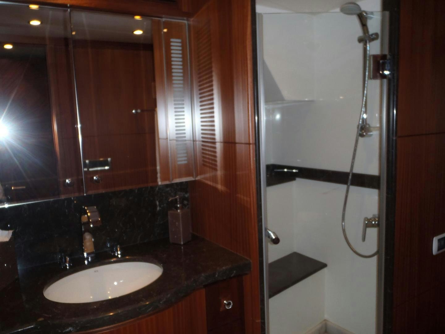 a bathroom with a sink and a shower aboard CLAYPEN Yacht for Sale