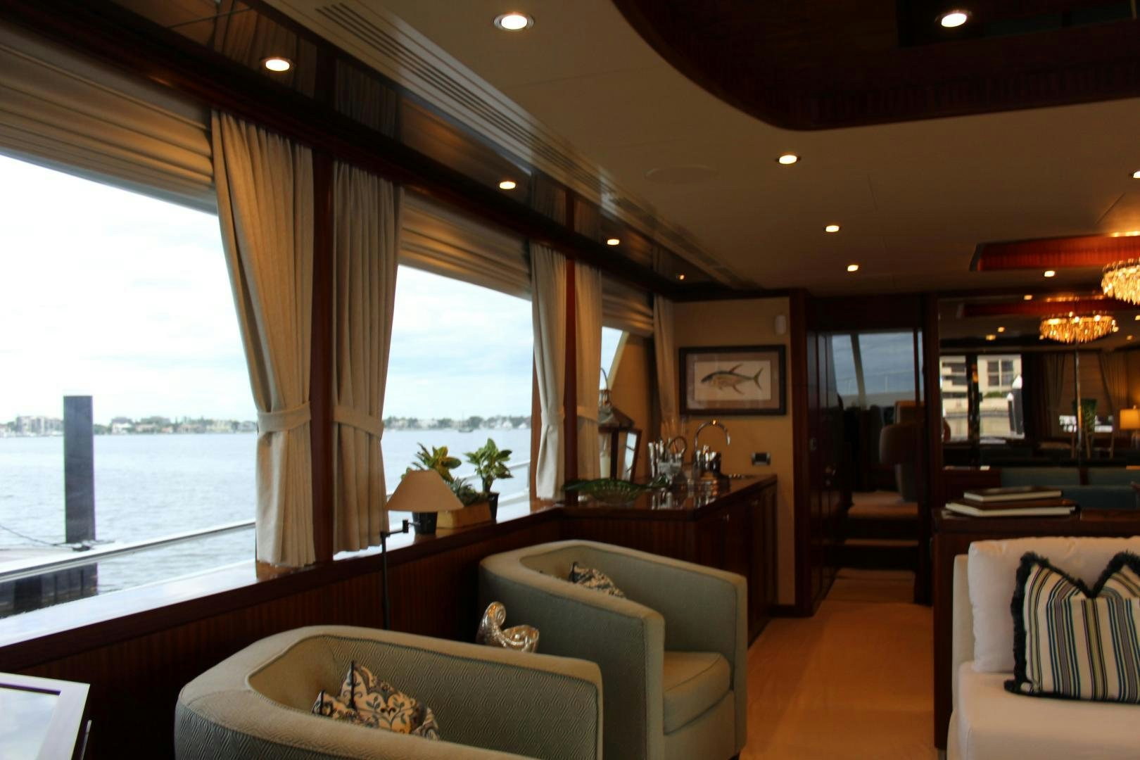 a living room with a large window aboard CLAYPEN Yacht for Sale