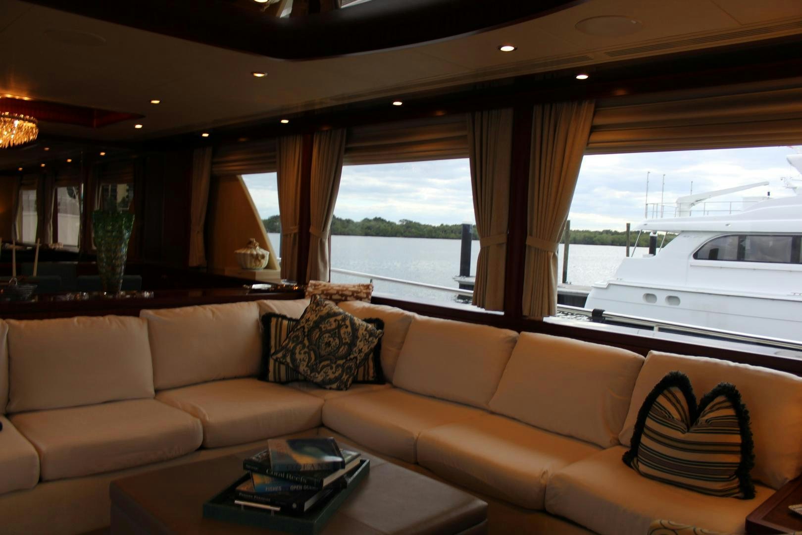 a living room with a couch and a table aboard CLAYPEN Yacht for Sale