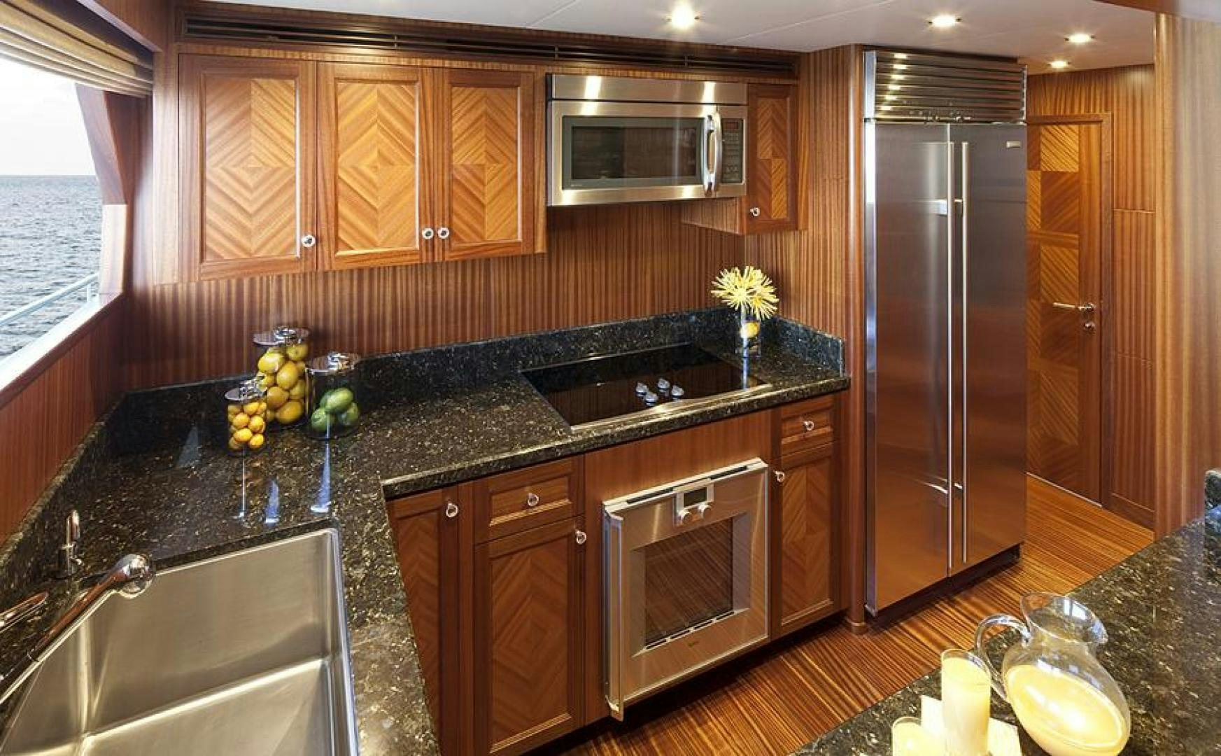 a kitchen with black appliances aboard CLAYPEN Yacht for Sale