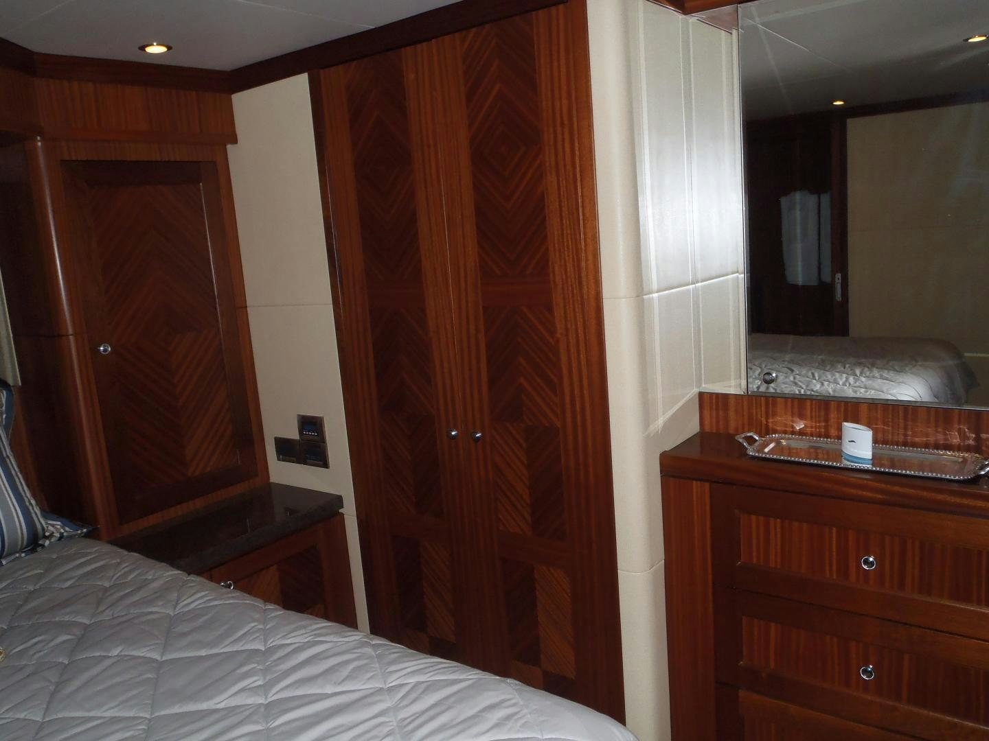 a bedroom with a bed and a closet aboard CLAYPEN Yacht for Sale