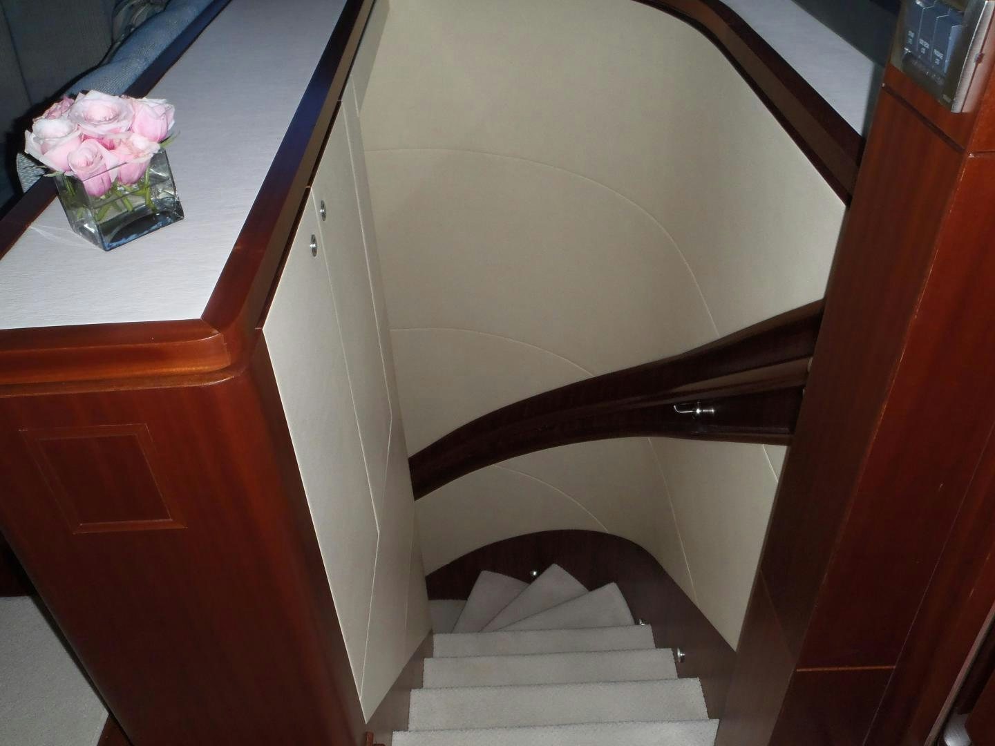 a white staircase with a pink rose on the top aboard CLAYPEN Yacht for Sale