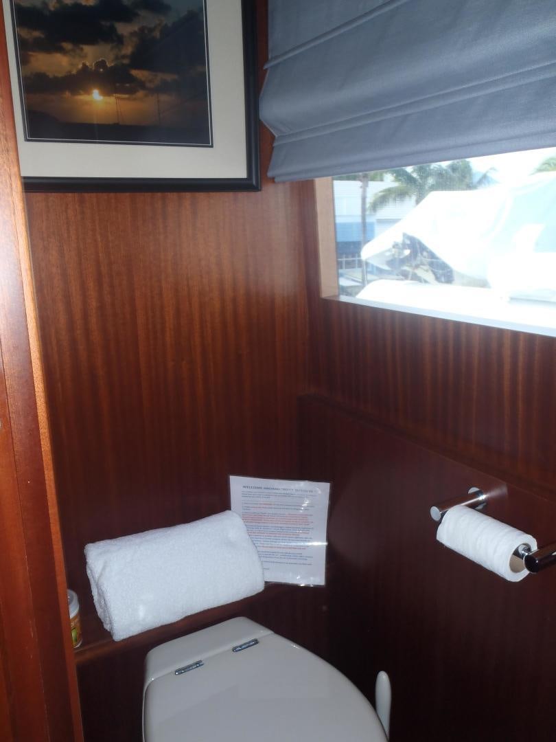 a toilet with a paper on the wall aboard CLAYPEN Yacht for Sale