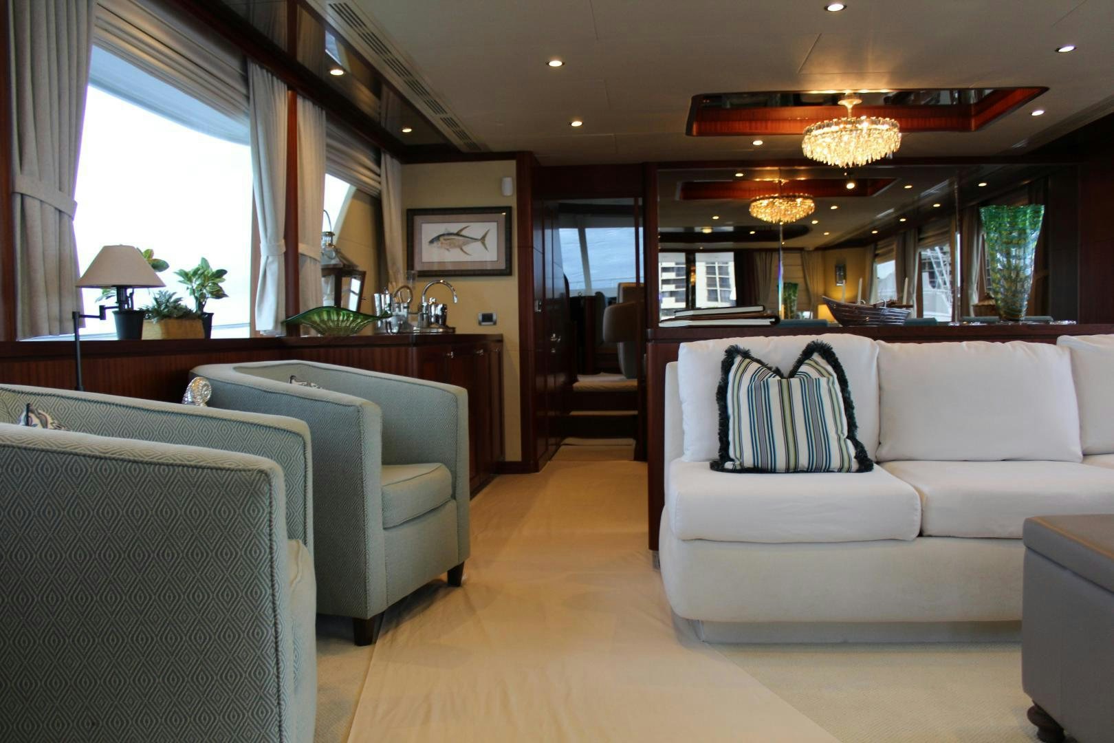 a living room with a couch and a piano aboard CLAYPEN Yacht for Sale
