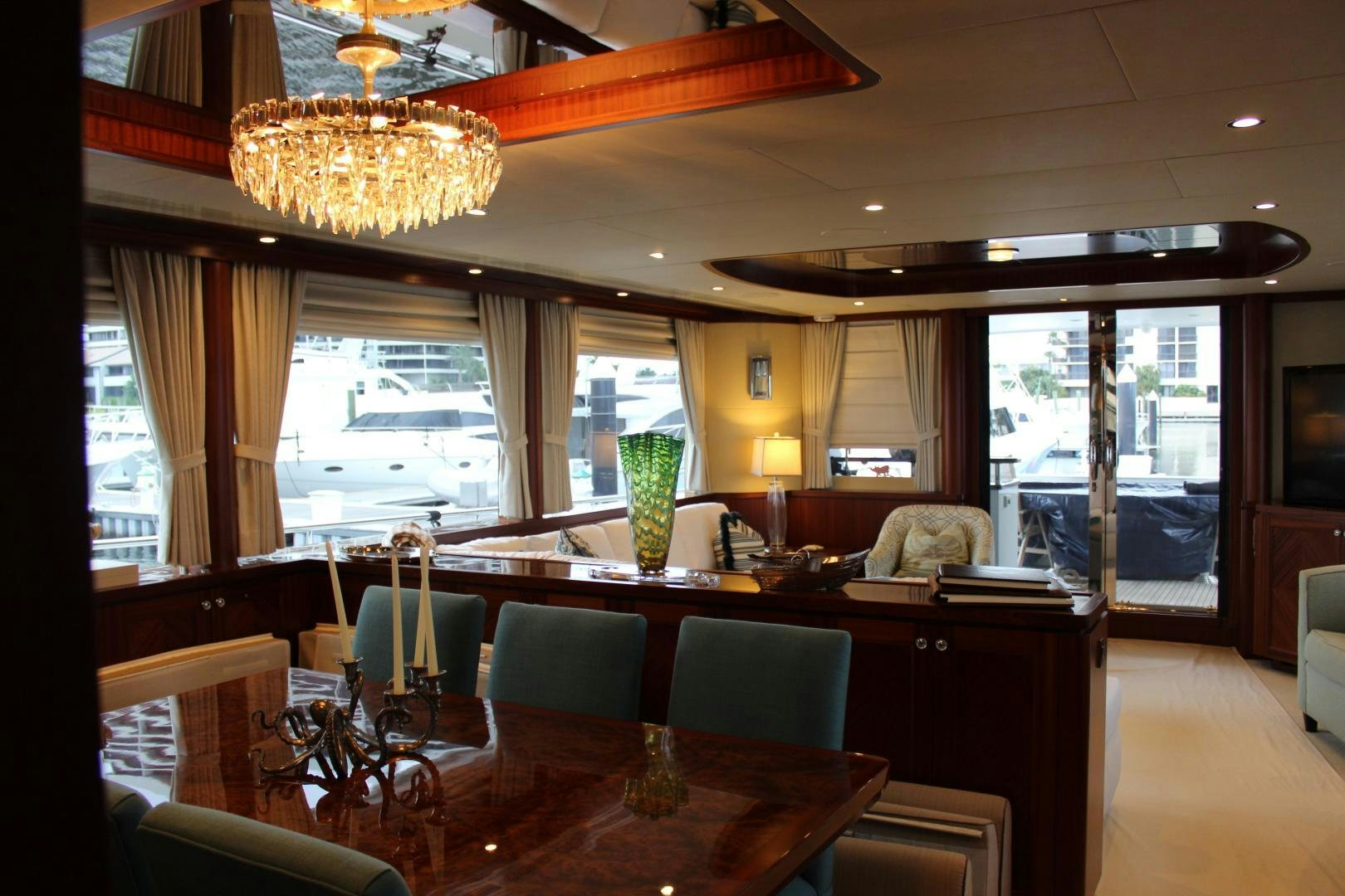 a large room with a chandelier and a table aboard CLAYPEN Yacht for Sale