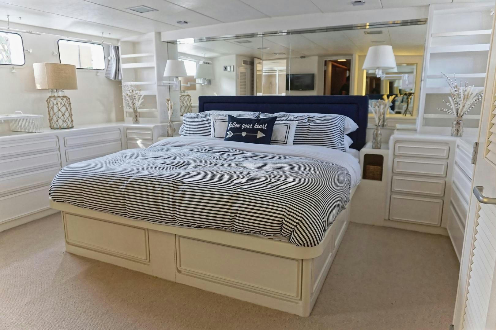 a bedroom with a bed and a desk aboard NO NAME Yacht for Sale