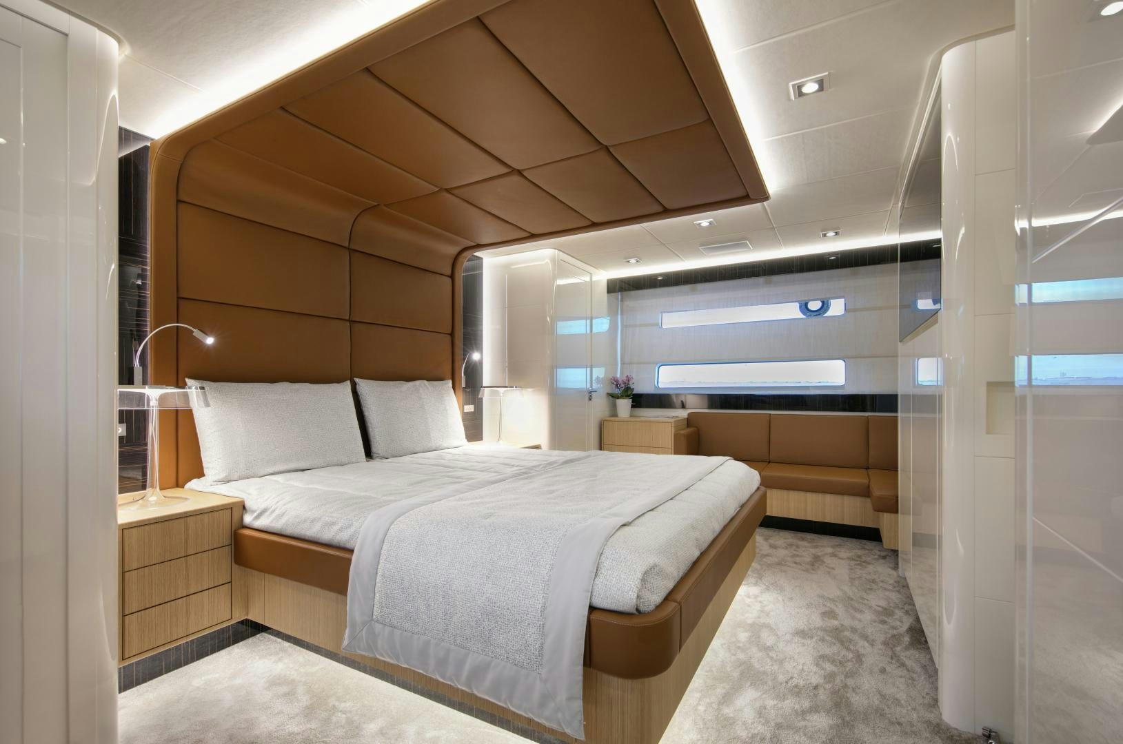 a room with a bed and a desk aboard URSUS V Yacht for Sale