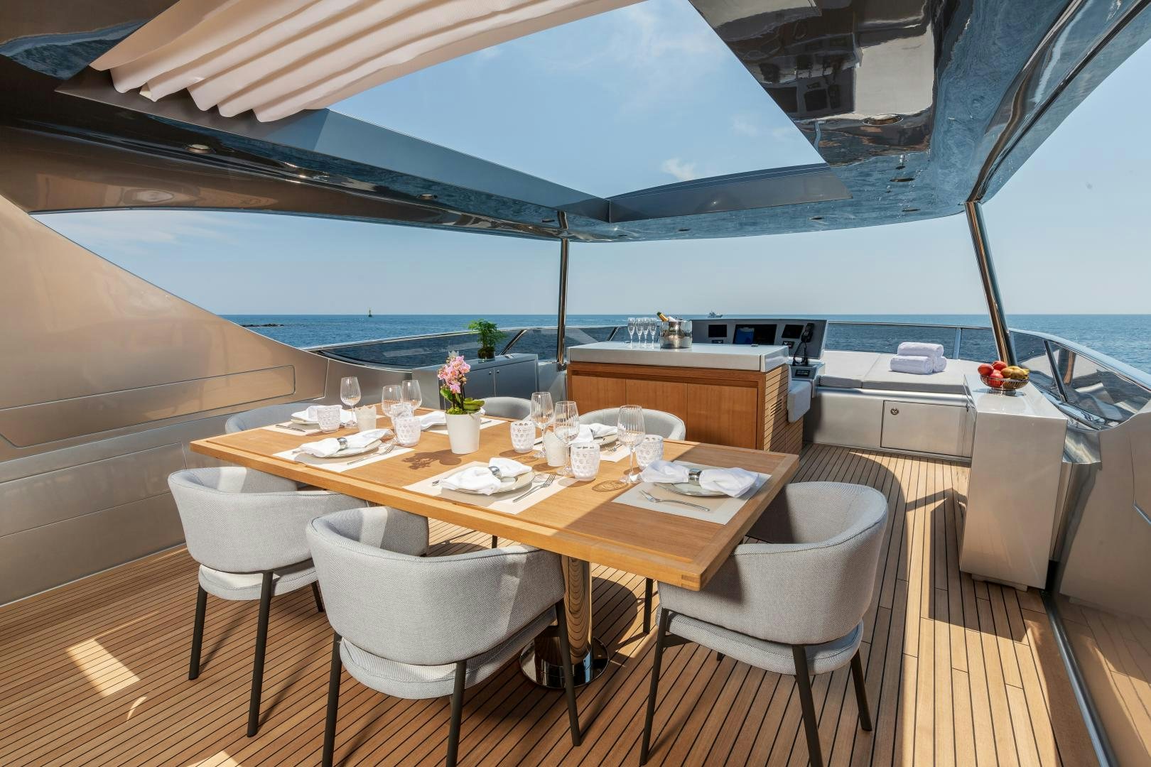 a table with chairs and a umbrella aboard URSUS V Yacht for Sale