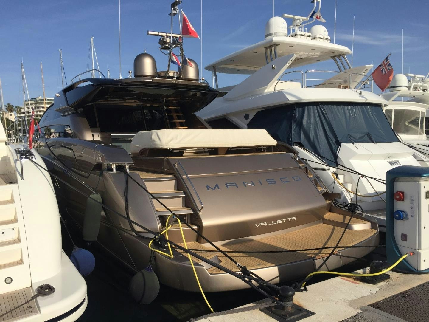 a boat with a black and white boat on it aboard MANISCO Yacht for Sale
