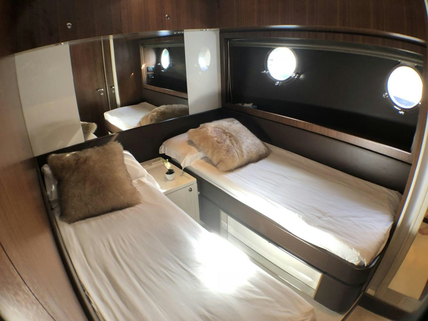 a bed with a white cover aboard MANISCO Yacht for Sale