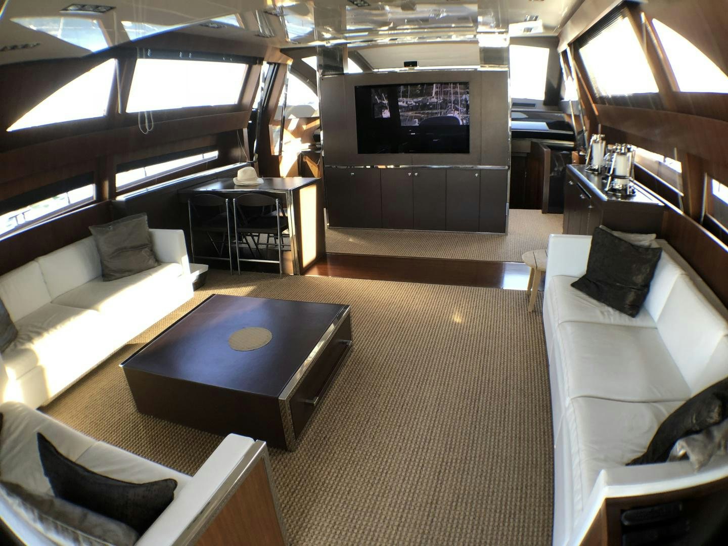 a living room with a tv and couches aboard MANISCO Yacht for Sale