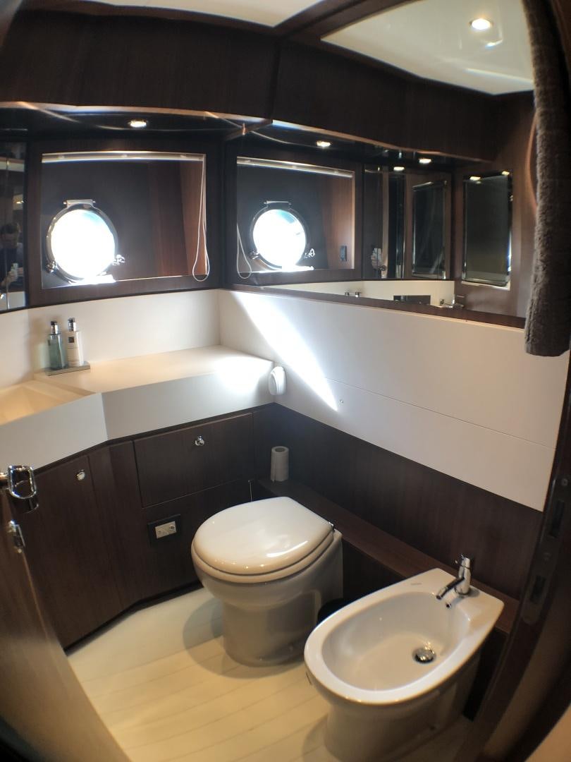 a bathroom with a toilet and a sink aboard MANISCO Yacht for Sale