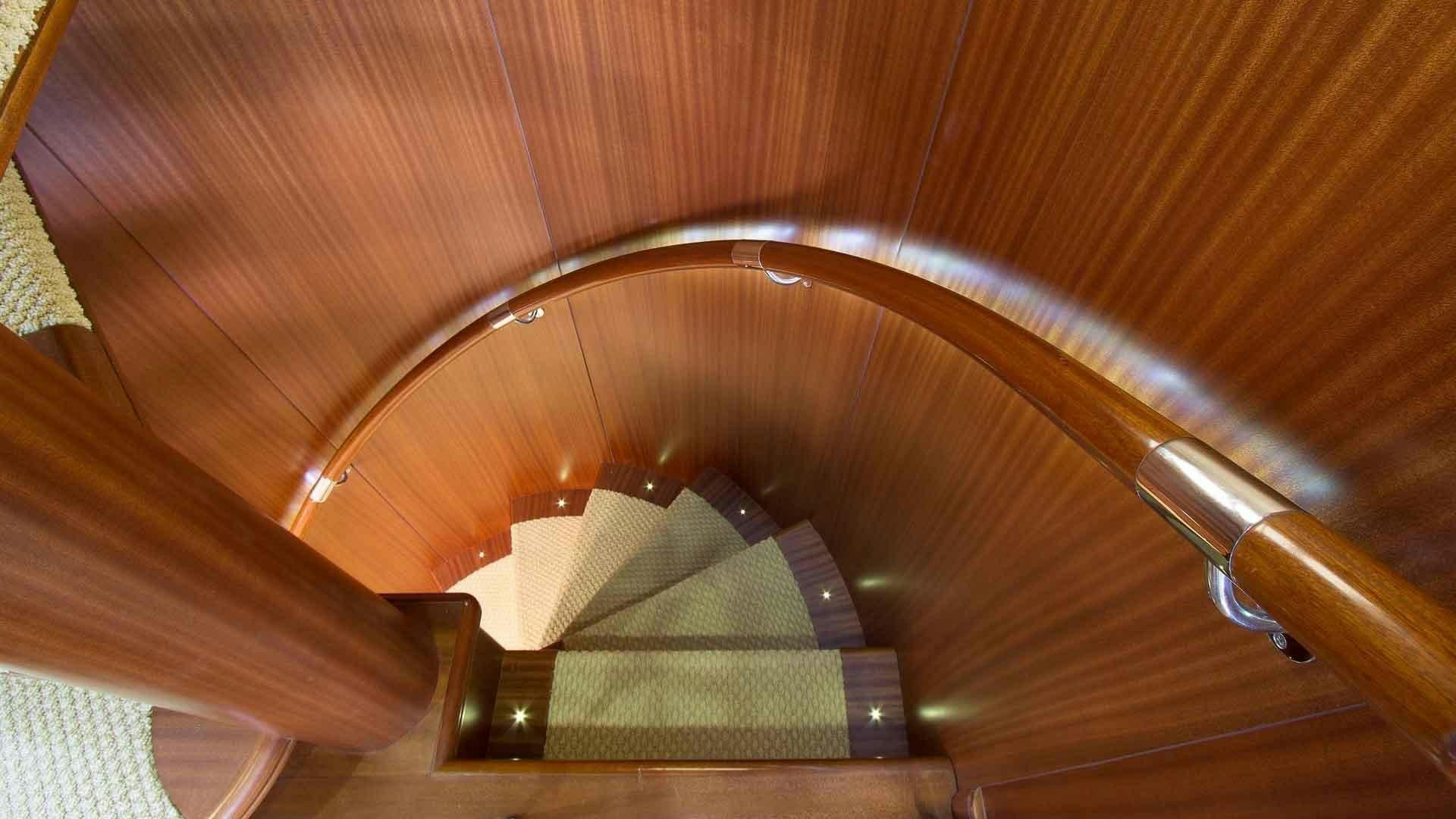 a wooden escalator with a metal railing aboard JUS CHILL'N Yacht for Sale